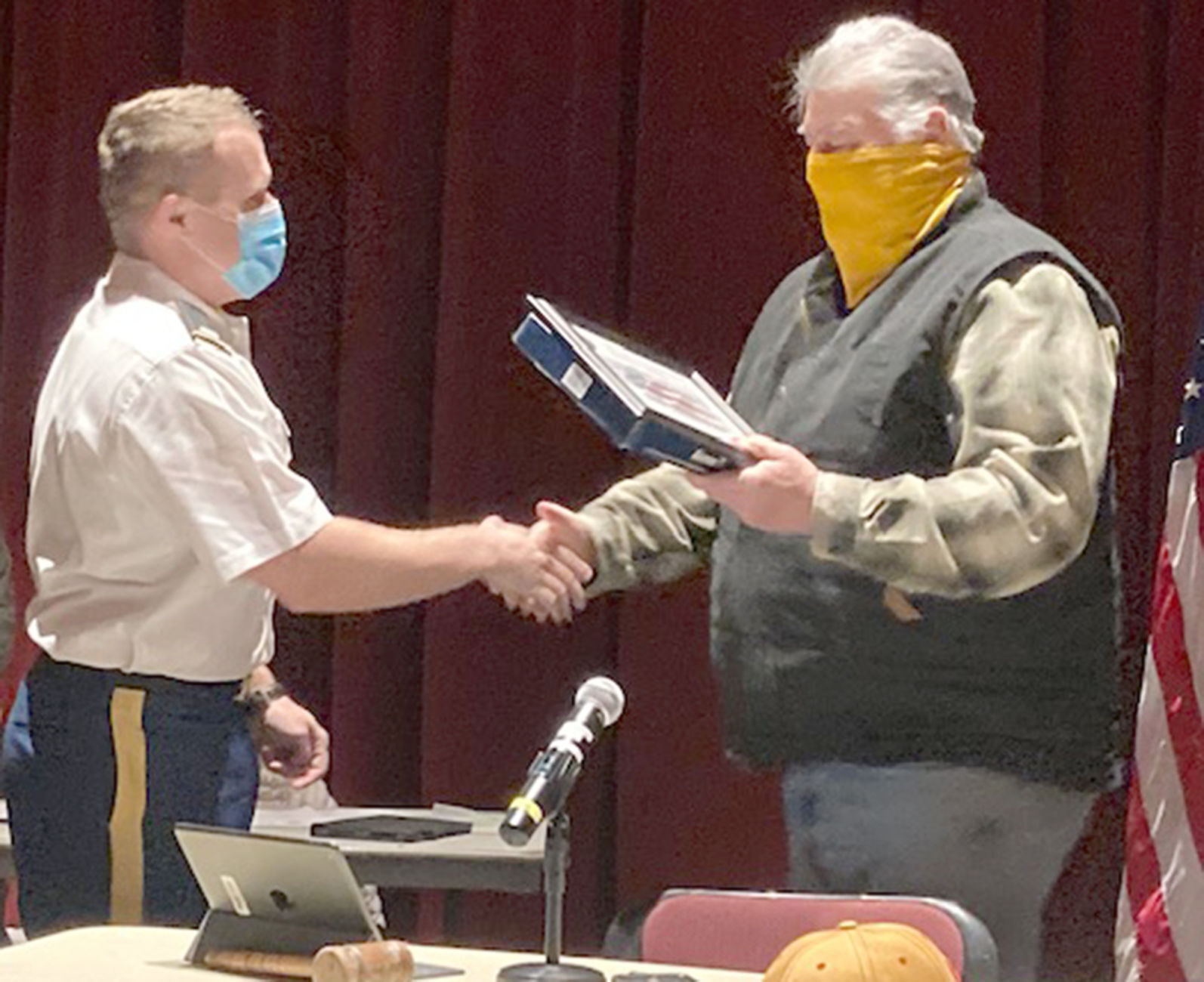 Flag presentation1st Lt. Kyle Myszka (left), a commissioned officer in the U.S. Army Reserves, presents a flag to Marinette County Board chairman John Guarisco Tuesday at the county board meeting. Myszka recently returned from an 11-month deployment in the Middle East. The flag presented to the board was flown in December 2020 at Camp Moreell, Ali Al Salem Air Base, Kuwait, during Operation Freedom’s Sentinel in honor of Marinette County. Myszka and his wife, Amber, and their son, Arthur, live in Marinette.Flag presentation
